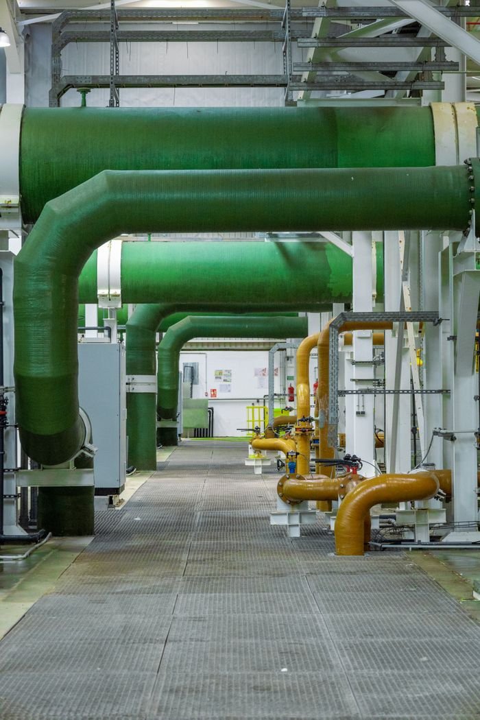 Crafting Captivating Headlines: Your awesome post title goes here Modern industrial interior featuring green and orange pipelines and technology.